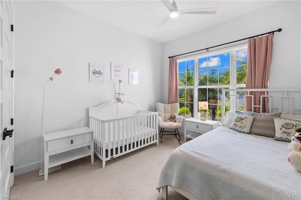6291 Arriba Avenue Naples, FL 34113 - Photo 17 of 43 a bedroom with two beds and a large window