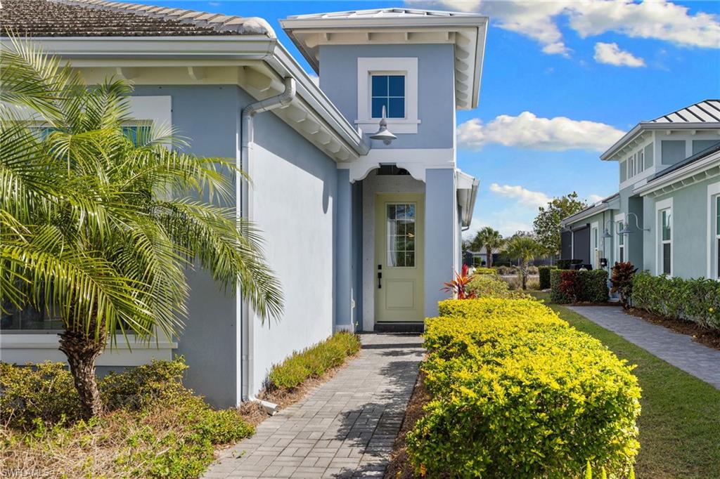 6291 Arriba Avenue Naples, FL 34113 - Photo 20 of 43 a front view of a house with garden