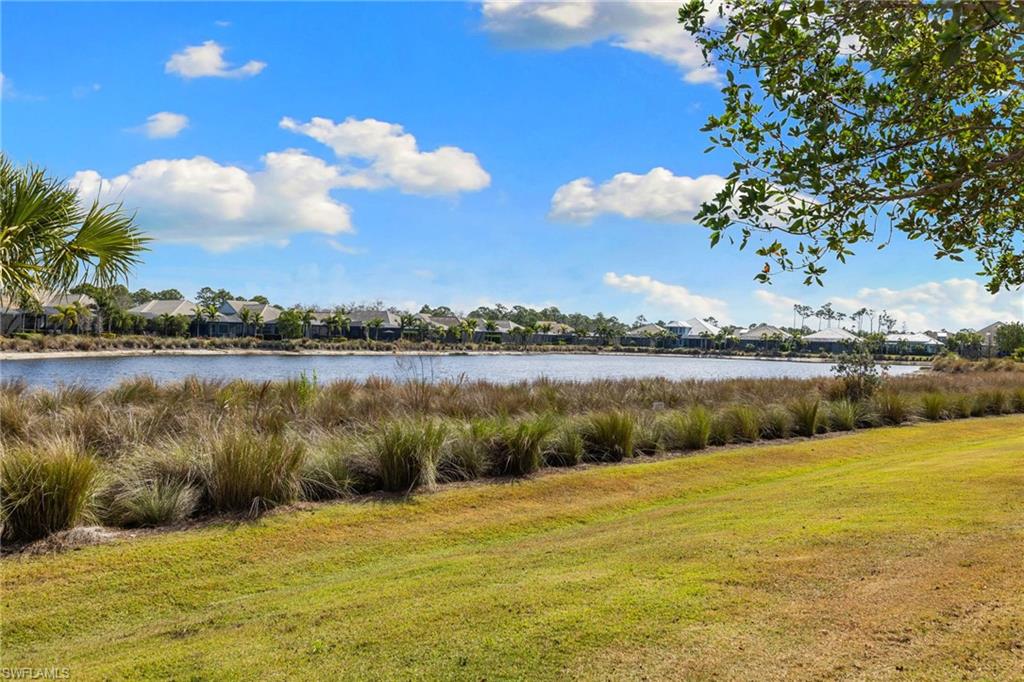 6291 Arriba Avenue Naples, FL 34113 - Photo 3 of 43 a view of a lake with a yard
