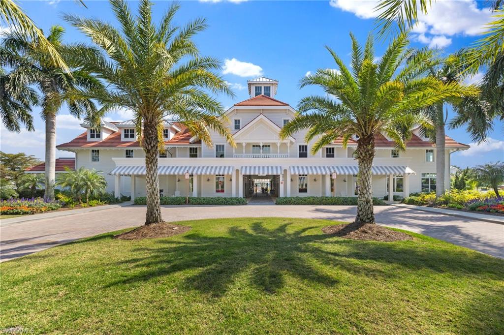 6291 Arriba Avenue Naples, FL 34113 - Photo 30 of 43 a front view of residential houses with yard and swimming pool
