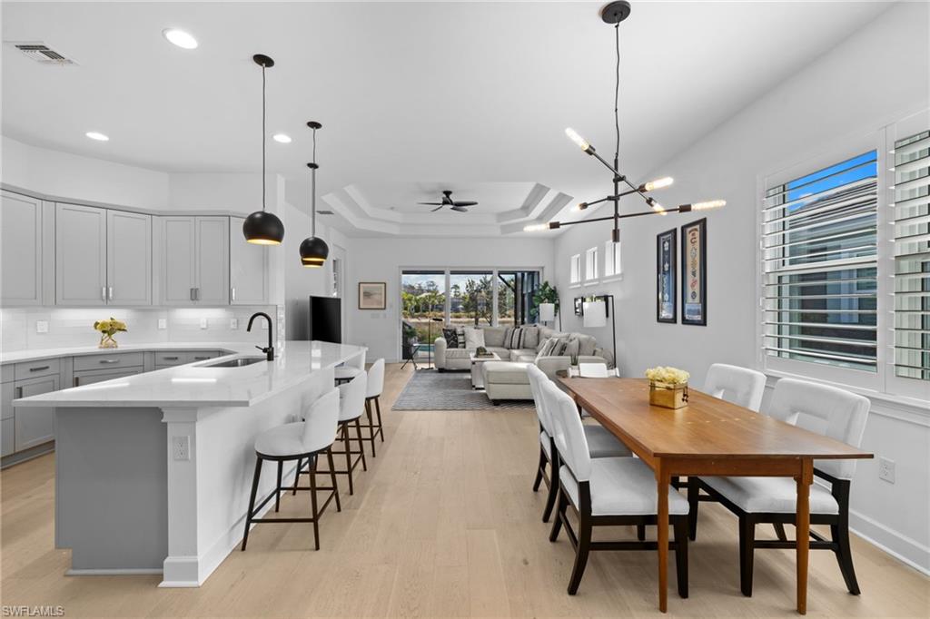 6291 Arriba Avenue Naples, FL 34113 - Photo 40 of 43 a view of a dining room with furniture and chandelier