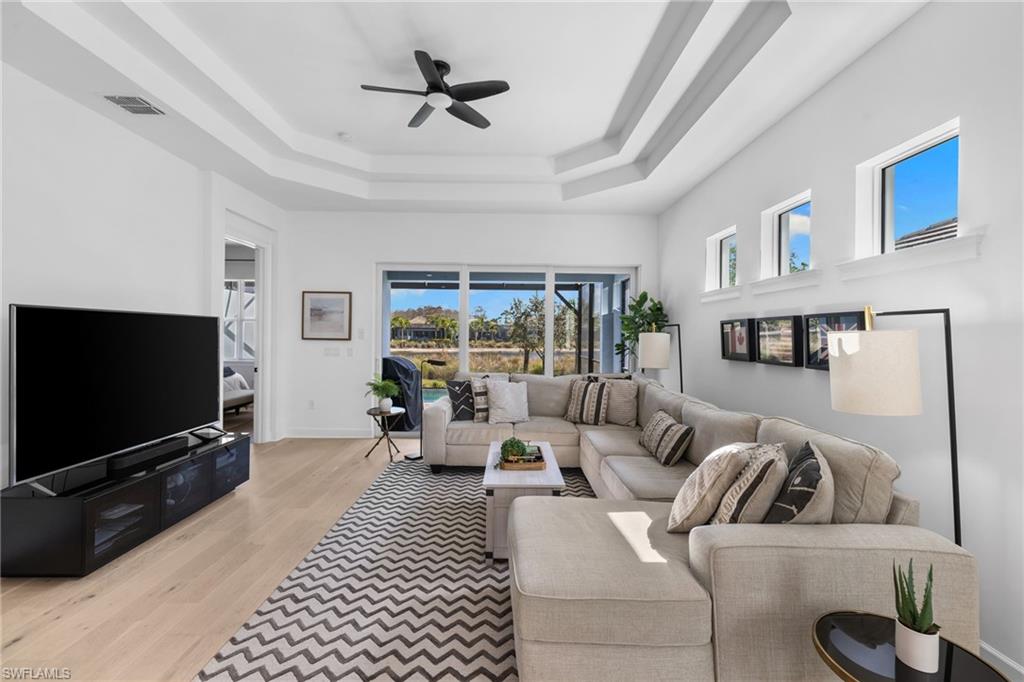 6291 Arriba Avenue Naples, FL 34113 - Photo 7 of 43 a living room with furniture and a flat screen tv