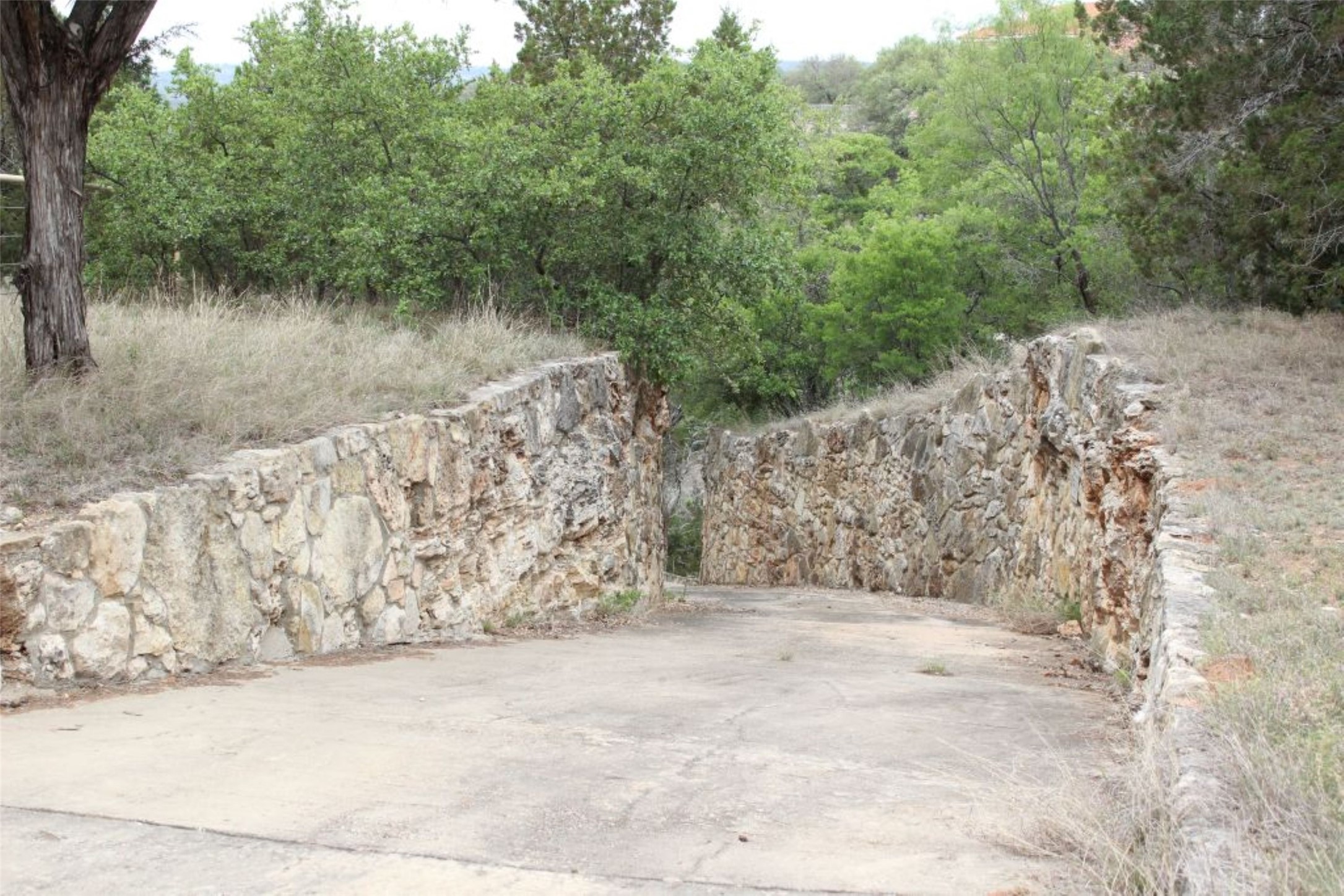 5135 Lookout Ridge Drive Marble Falls, TX 78654 - Photo 9 of 33 Stone walled driveway behind Barn down to Lake Travis