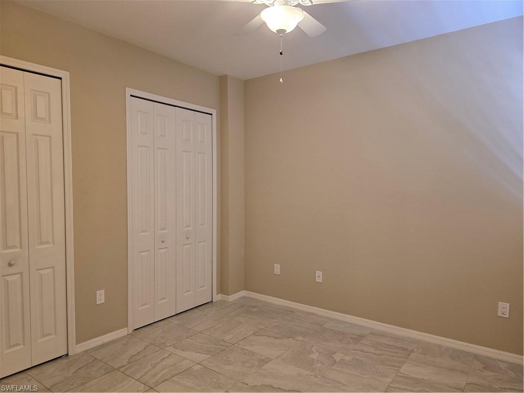 1020 Peggy Circle, Unit 101 Naples, FL 34113 - Photo 11 of 30 an empty room with a ceiling fan