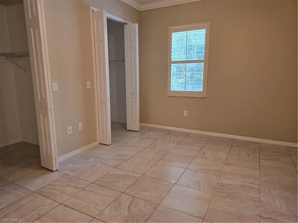 1020 Peggy Circle, Unit 101 Naples, FL 34113 - Photo 12 of 30 an empty room with windows