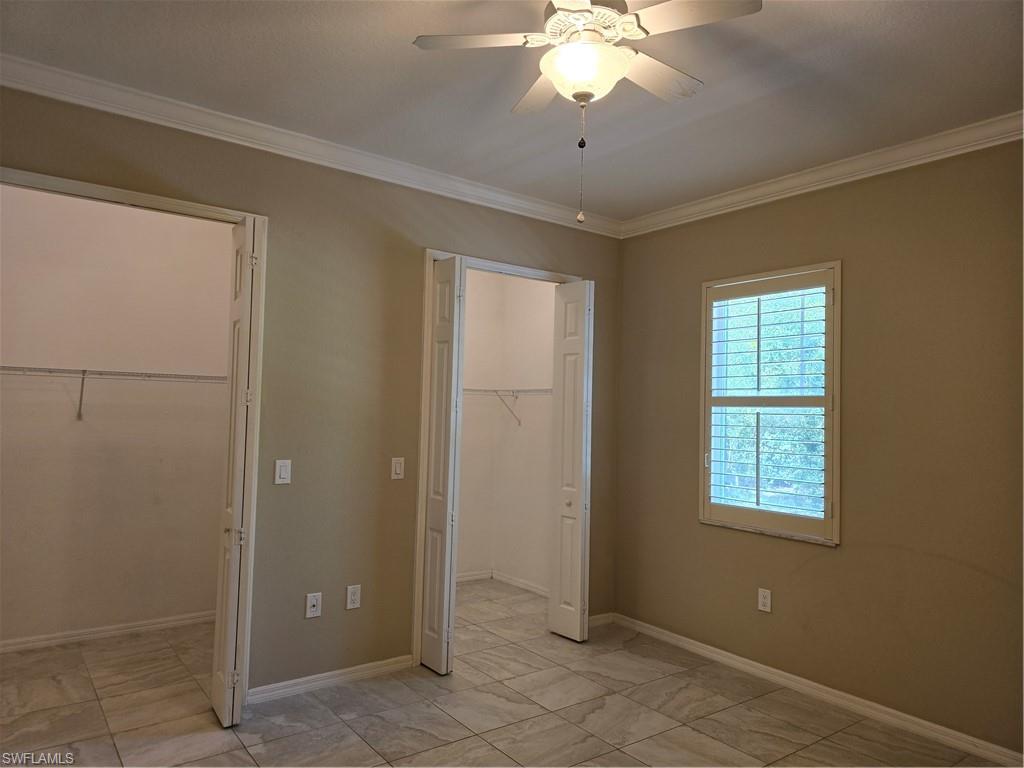 1020 Peggy Circle, Unit 101 Naples, FL 34113 - Photo 13 of 30 a view of a livingroom with a chandelier fan and windows