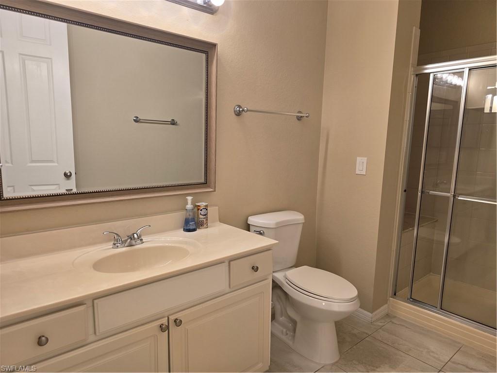 1020 Peggy Circle, Unit 101 Naples, FL 34113 - Photo 14 of 30 a bathroom with a sink a toilet and shower