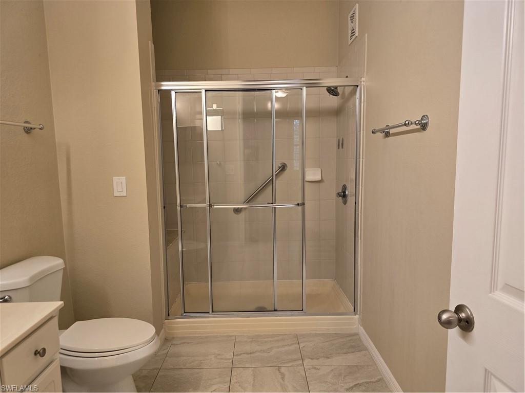 1020 Peggy Circle, Unit 101 Naples, FL 34113 - Photo 15 of 30 a bathroom with a shower a toilet and a sink