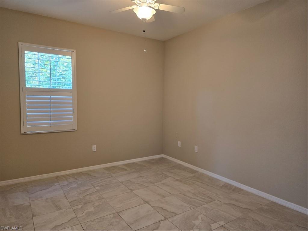1020 Peggy Circle, Unit 101 Naples, FL 34113 - Photo 17 of 30 an empty room with a fan & a window