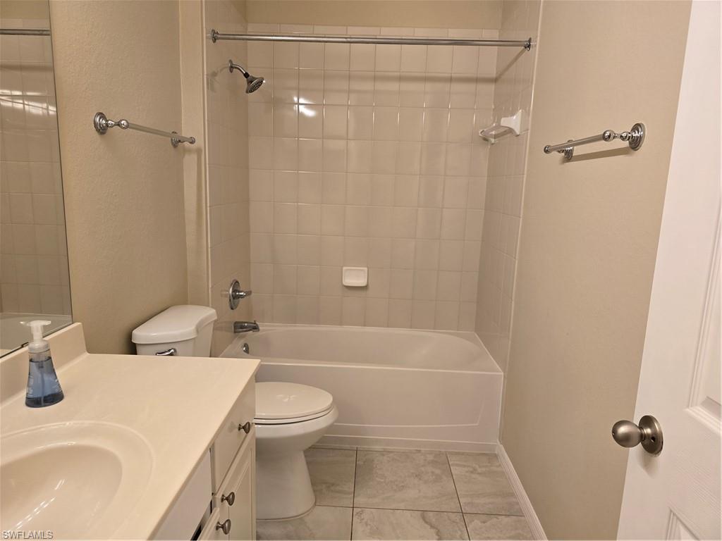 1020 Peggy Circle, Unit 101 Naples, FL 34113 - Photo 20 of 30 a bathroom with a sink a toilet and shower