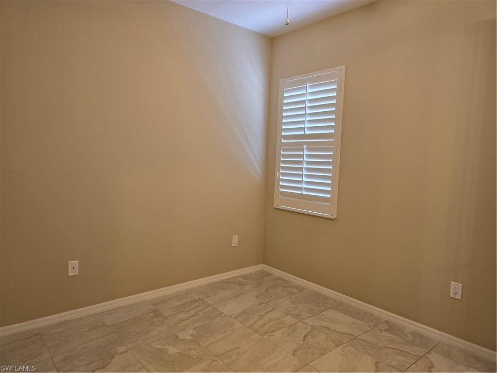 1020 Peggy Circle, Unit 101 Naples, FL 34113 - Photo 22 of 30 an empty room with windows
