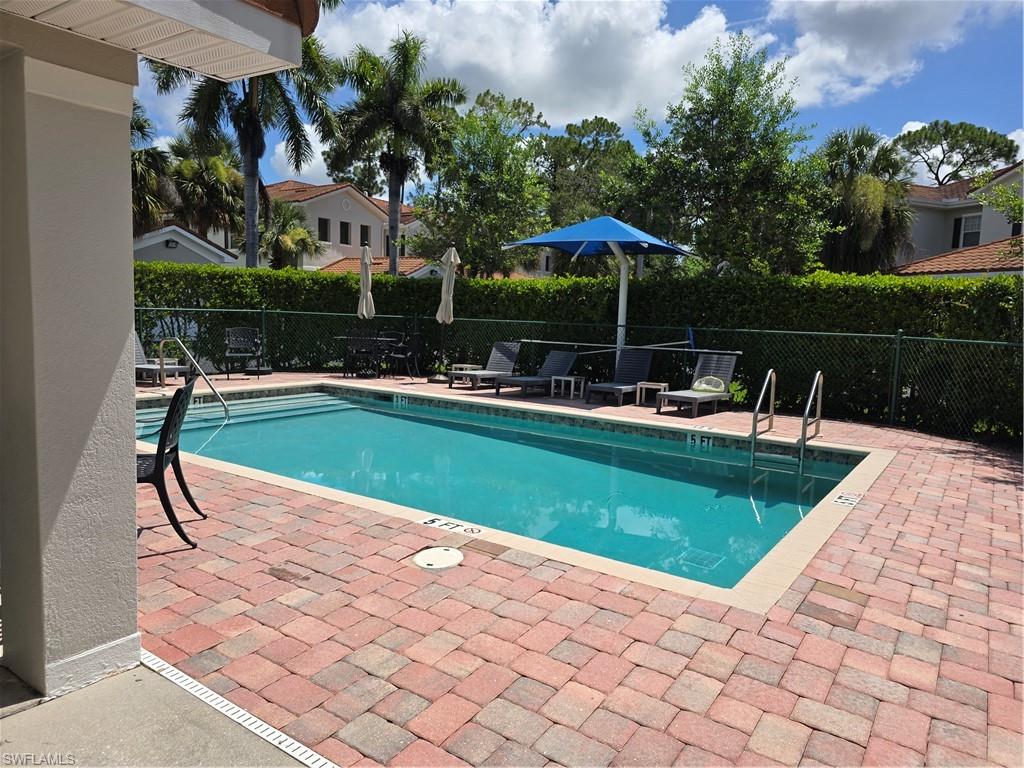 1020 Peggy Circle, Unit 101 Naples, FL 34113 - Photo 28 of 30 a view of a swimming pool with a patio