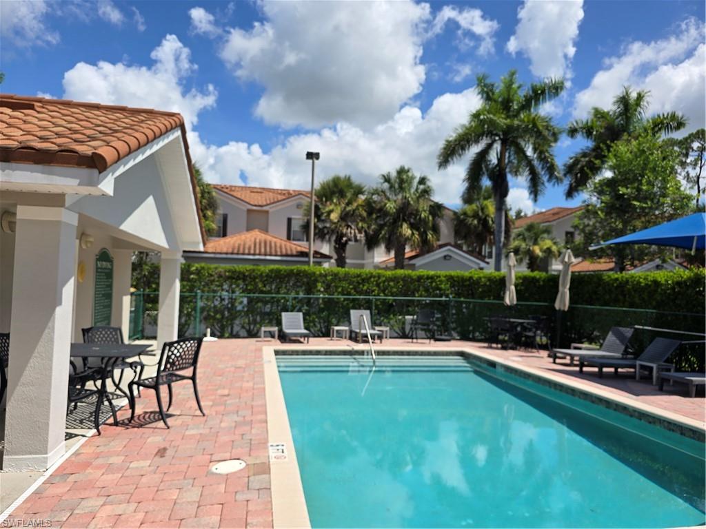 1020 Peggy Circle, Unit 101 Naples, FL 34113 - Photo 29 of 30 a view of a swimming pool with chairs