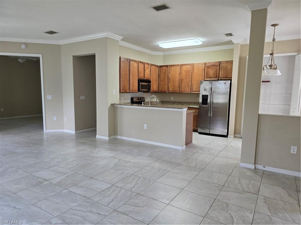 1020 Peggy Circle, Unit 101 Naples, FL 34113 - Photo 3 of 30 a view of a kitchen with a sink and refrigerator