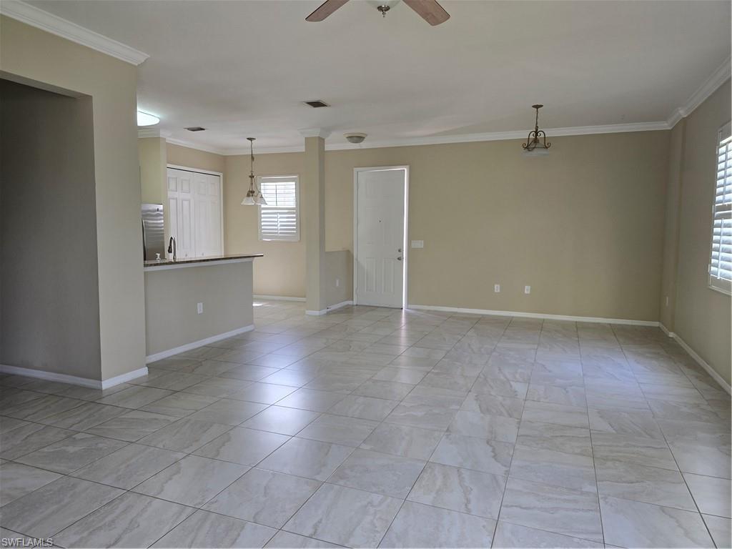 1020 Peggy Circle, Unit 101 Naples, FL 34113 - Photo 4 of 30 wooden floor in an empty room with a kitchen