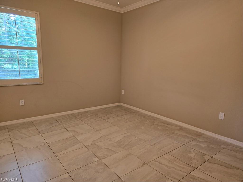 1020 Peggy Circle, Unit 101 Naples, FL 34113 - Photo 9 of 30 an empty room with a window