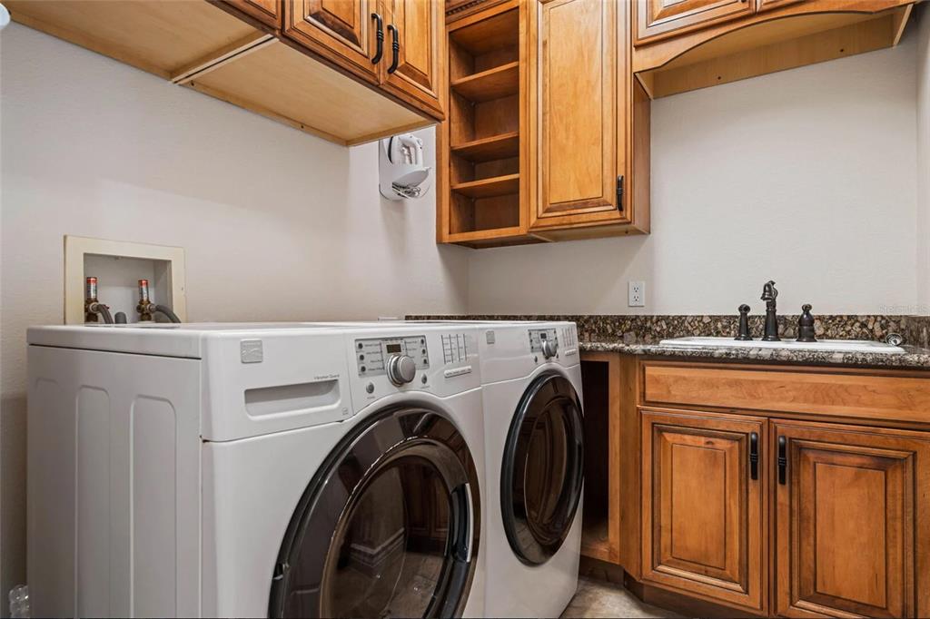 304 Muirfield Loop Reunion, FL 34747 - Photo 50 of 85 a utility room with dryer and washer