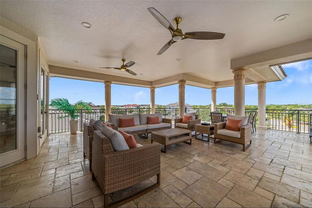 304 Muirfield Loop Reunion, FL 34747 - Photo 55 of 85 a living room with patio furniture and a floor to ceiling window