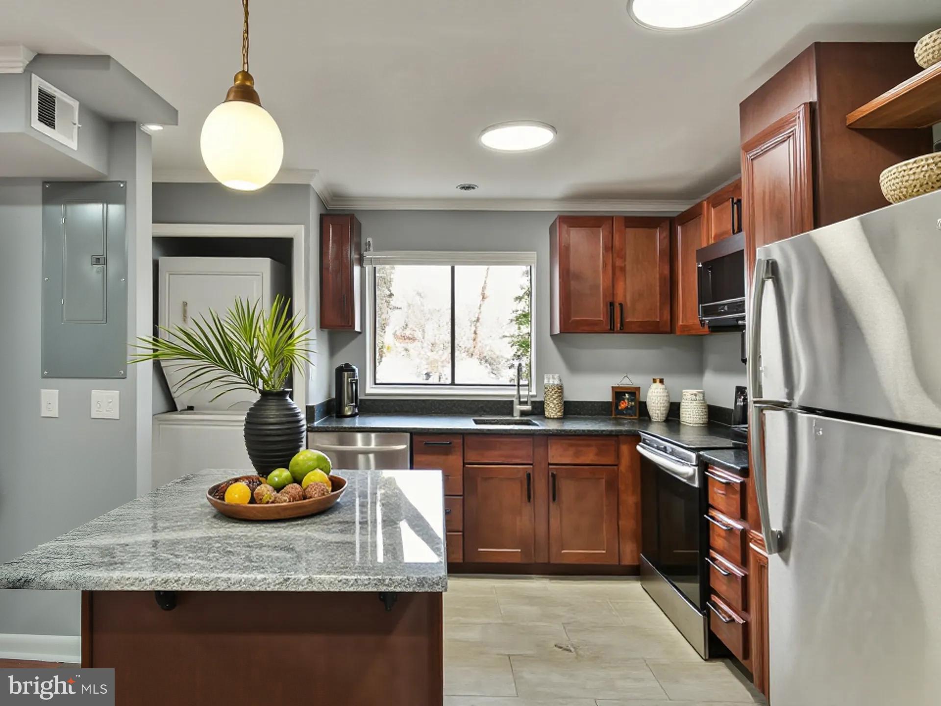 15712 Dorset Road, Unit 104 Laurel, MD 20707 - Photo 16 of 49 a kitchen with a refrigerator and a sink