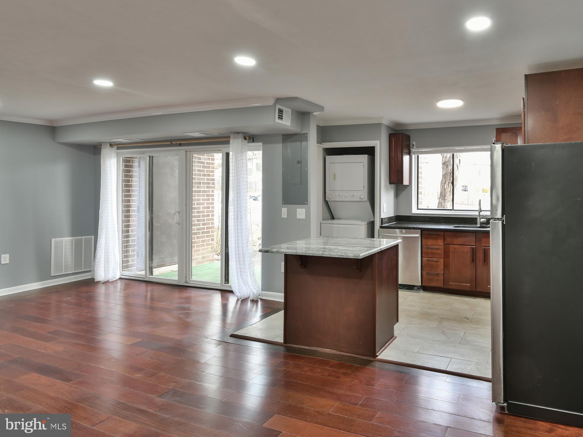 15712 Dorset Road, Unit 104 Laurel, MD 20707 - Photo 18 of 49 a kitchen with granite countertop a stove a sink and a refrigerator