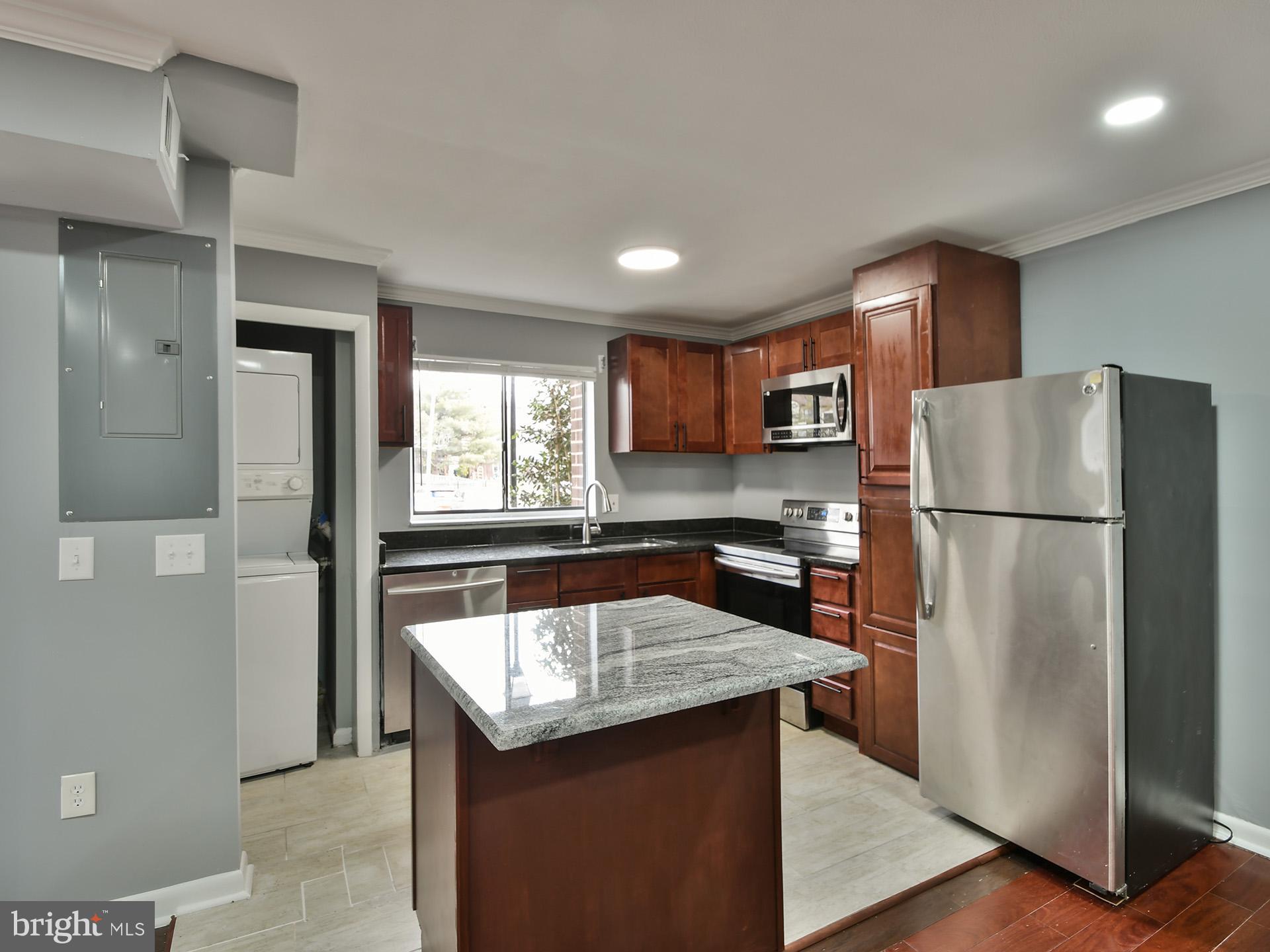 15712 Dorset Road, Unit 104 Laurel, MD 20707 - Photo 19 of 49 a kitchen with refrigerator and a sink