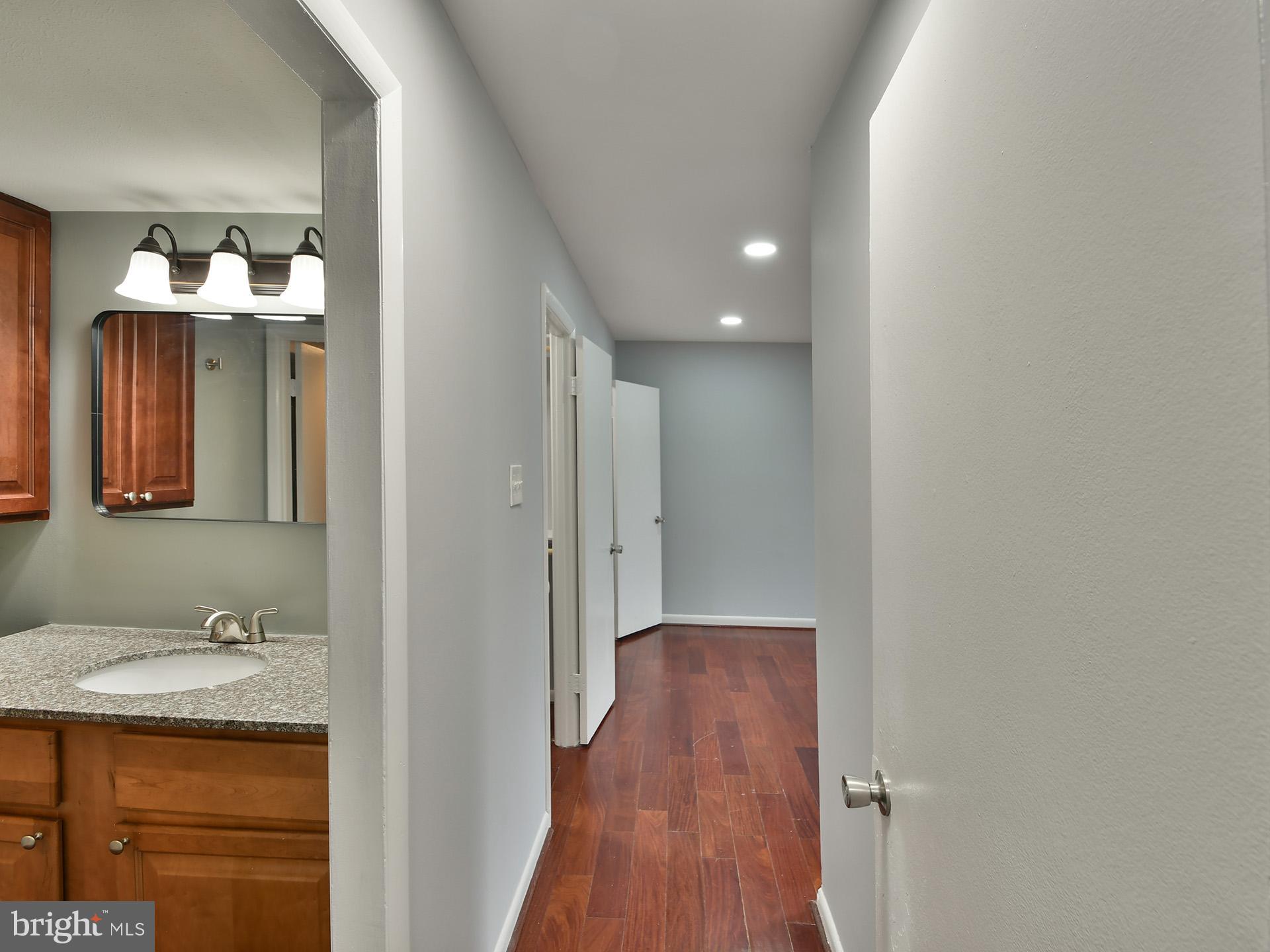 15712 Dorset Road, Unit 104 Laurel, MD 20707 - Photo 22 of 49 a bathroom with a sink and a mirror