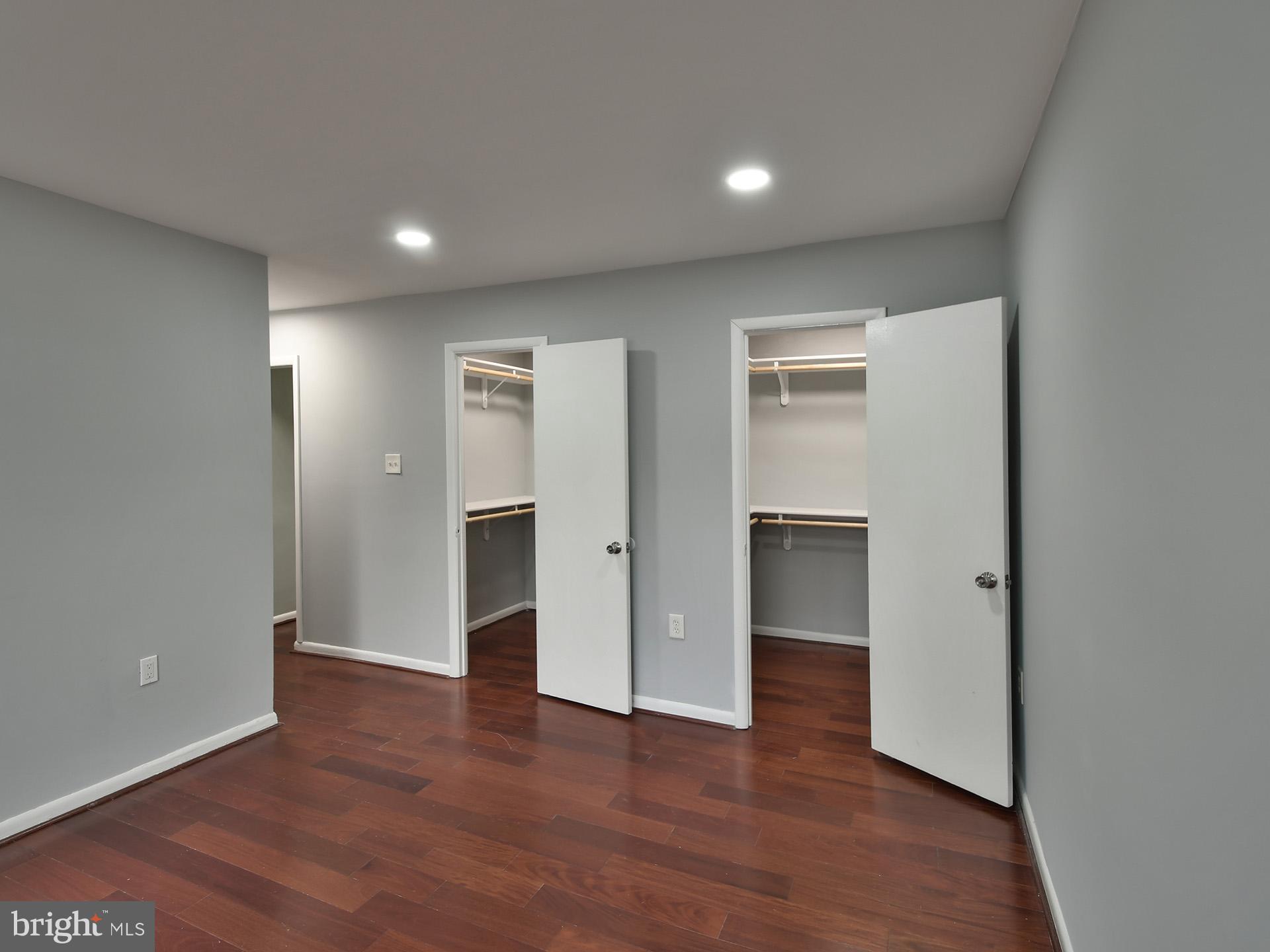 15712 Dorset Road, Unit 104 Laurel, MD 20707 - Photo 26 of 49 a view of an empty room with wooden floor and closet