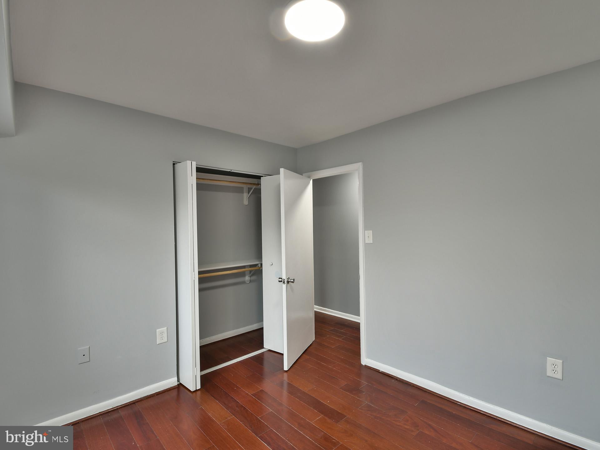 15712 Dorset Road, Unit 104 Laurel, MD 20707 - Photo 32 of 49 a view of an empty room with wooden floor