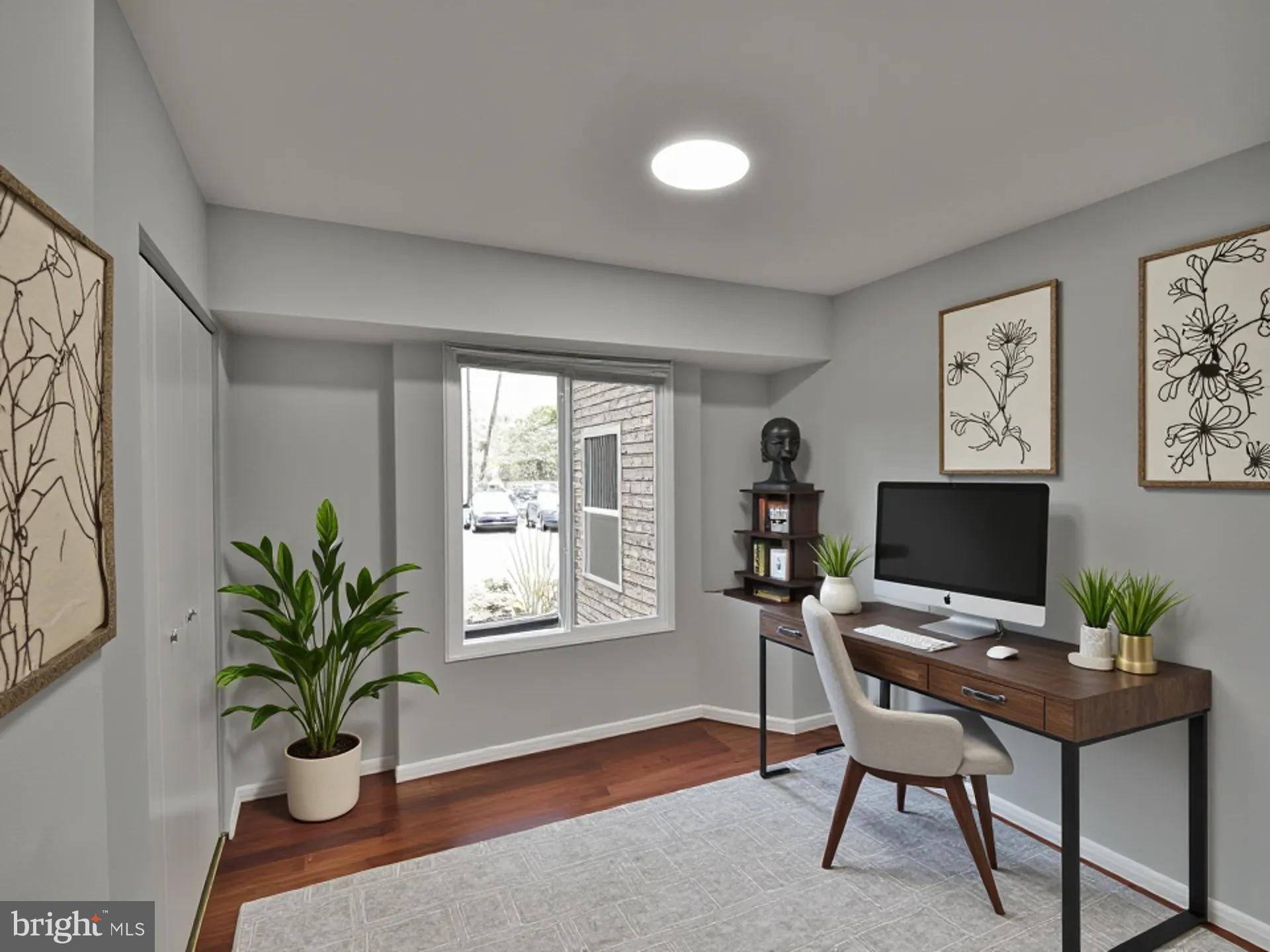 15712 Dorset Road, Unit 104 Laurel, MD 20707 - Photo 36 of 49 a view of a workspace with furniture and a potted plant