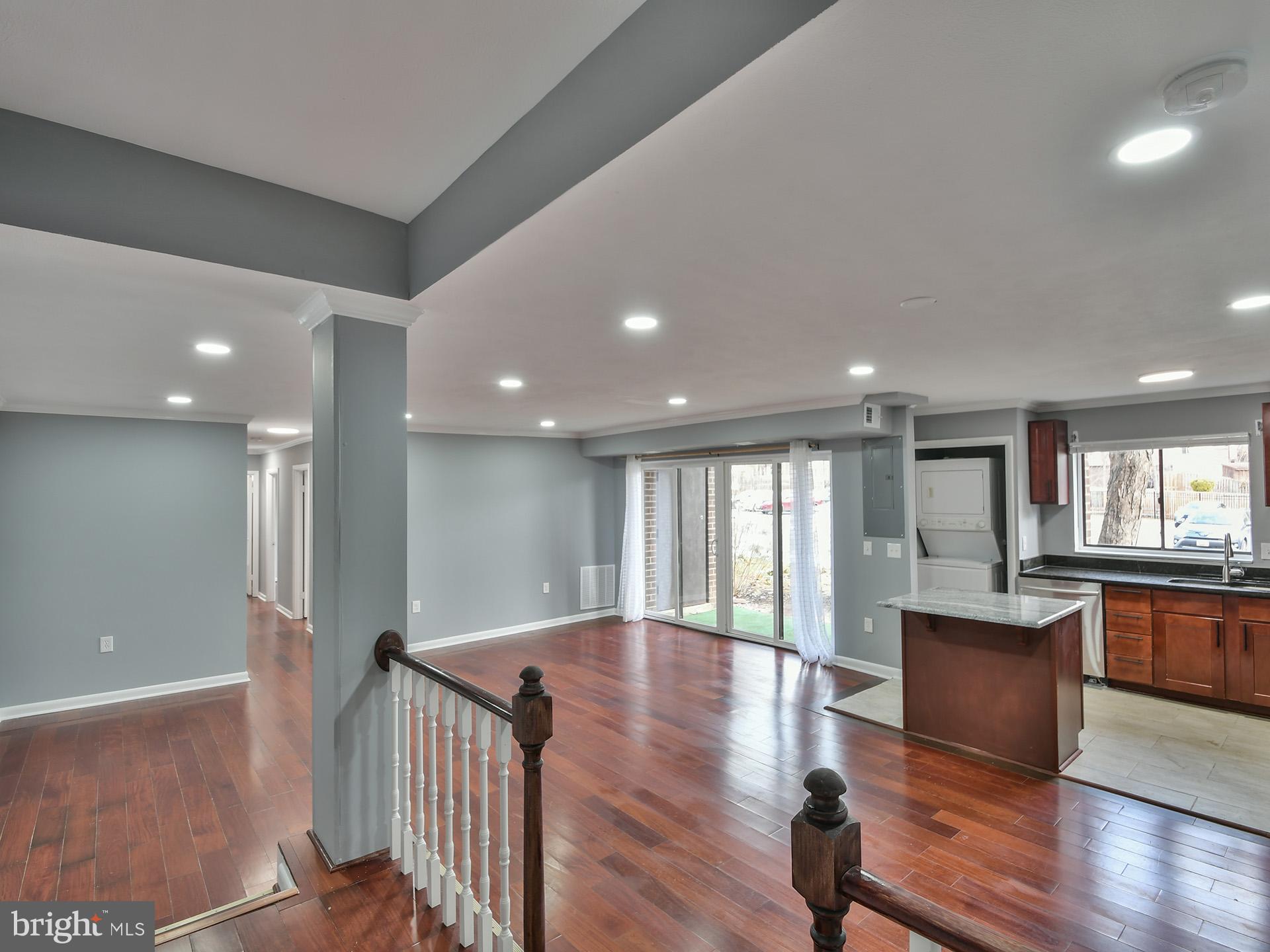 15712 Dorset Road, Unit 104 Laurel, MD 20707 - Photo 7 of 49 a view of a hallway with wooden floor and seating