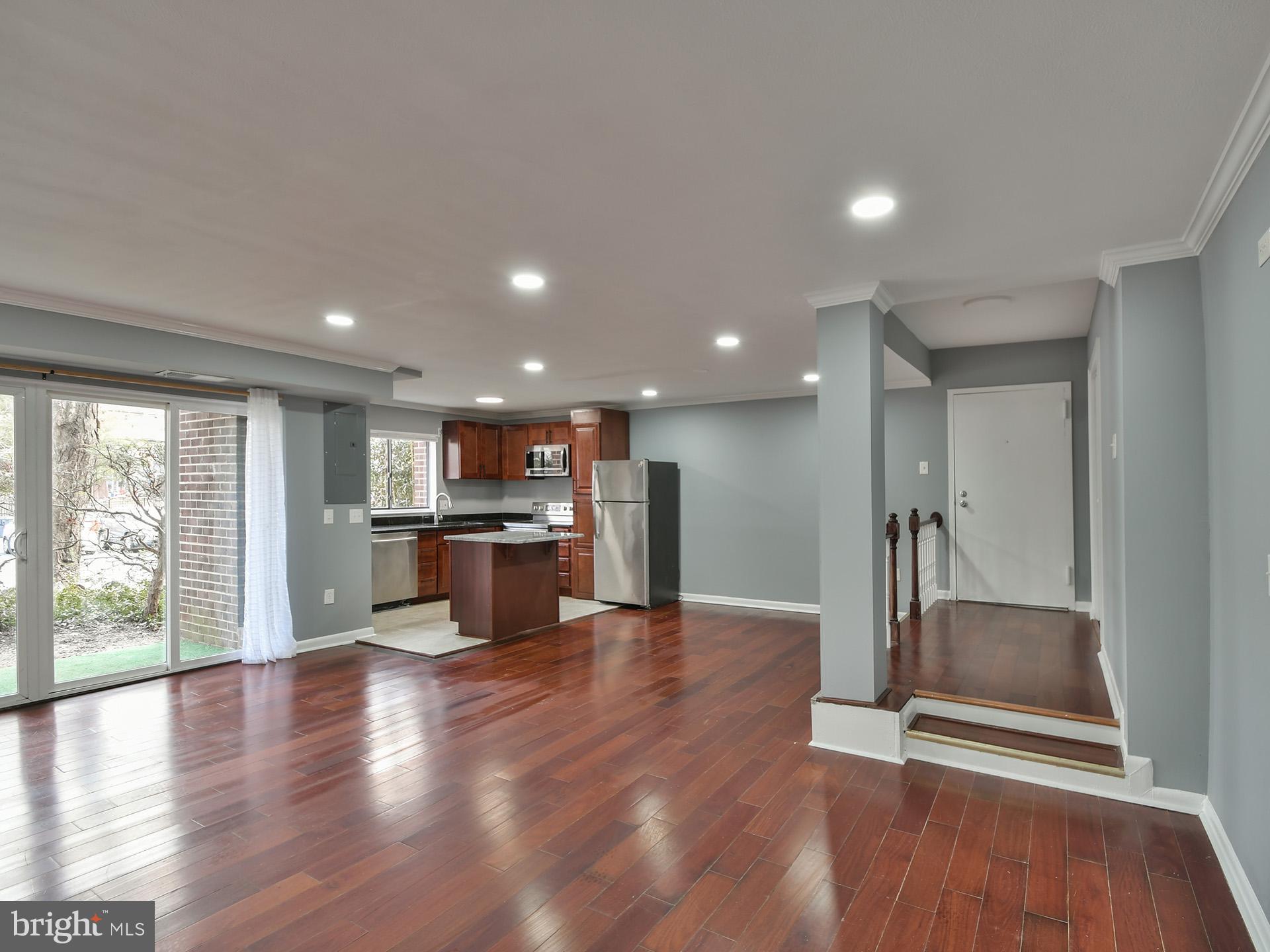 15712 Dorset Road, Unit 104 Laurel, MD 20707 - Photo 8 of 49 a open kitchen with stainless steel appliances granite countertop a refrigerator a sink a stove and a wooden cabinets with wooden floor