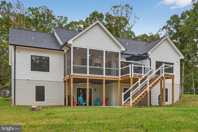 a view of a house with a yard and sitting area