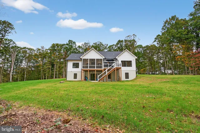 a bedroom with bed and a flat screen tv