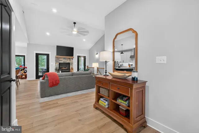 a living room with furniture a flat screen tv and a fireplace