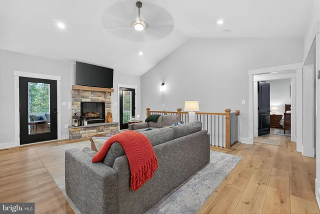 a living room with furniture flat screen tv and a fireplace