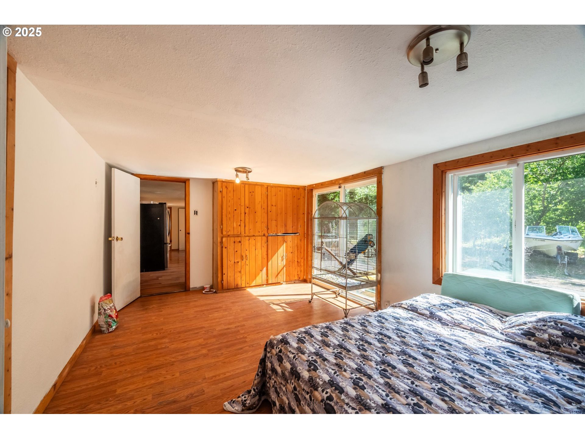 87720 Two Mile Lane Bandon, OR 97411 - Photo 16 of 35 a bedroom with a bed and large windows