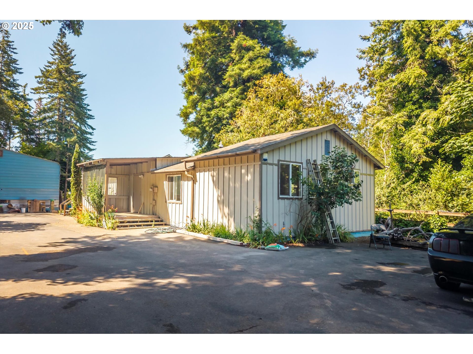 87720 Two Mile Lane Bandon, OR 97411 - Photo 2 of 35 a backyard of a house with garden and tree