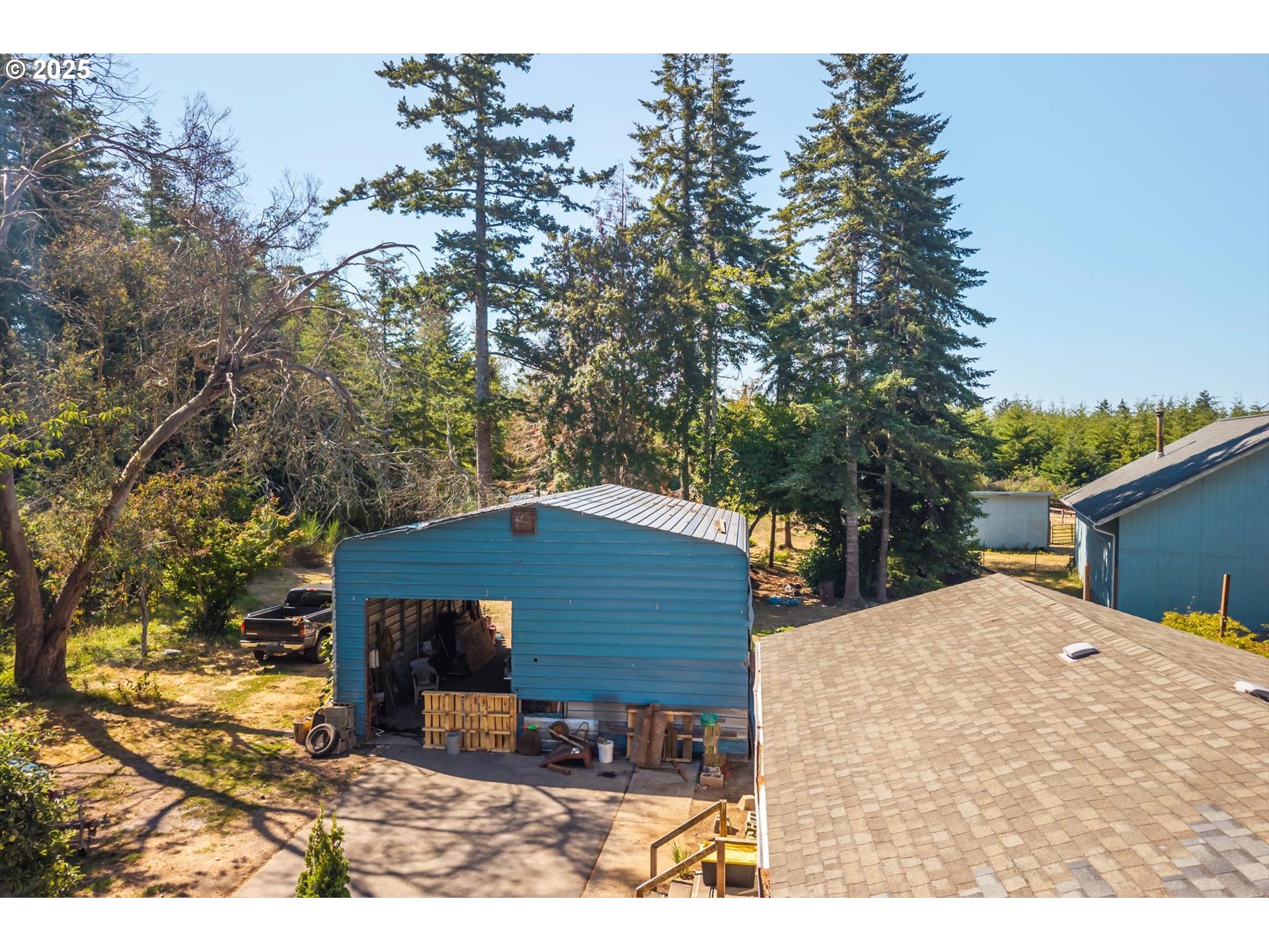 87720 Two Mile Lane Bandon, OR 97411 - Photo 30 of 35 a backyard of a house with table and chairs