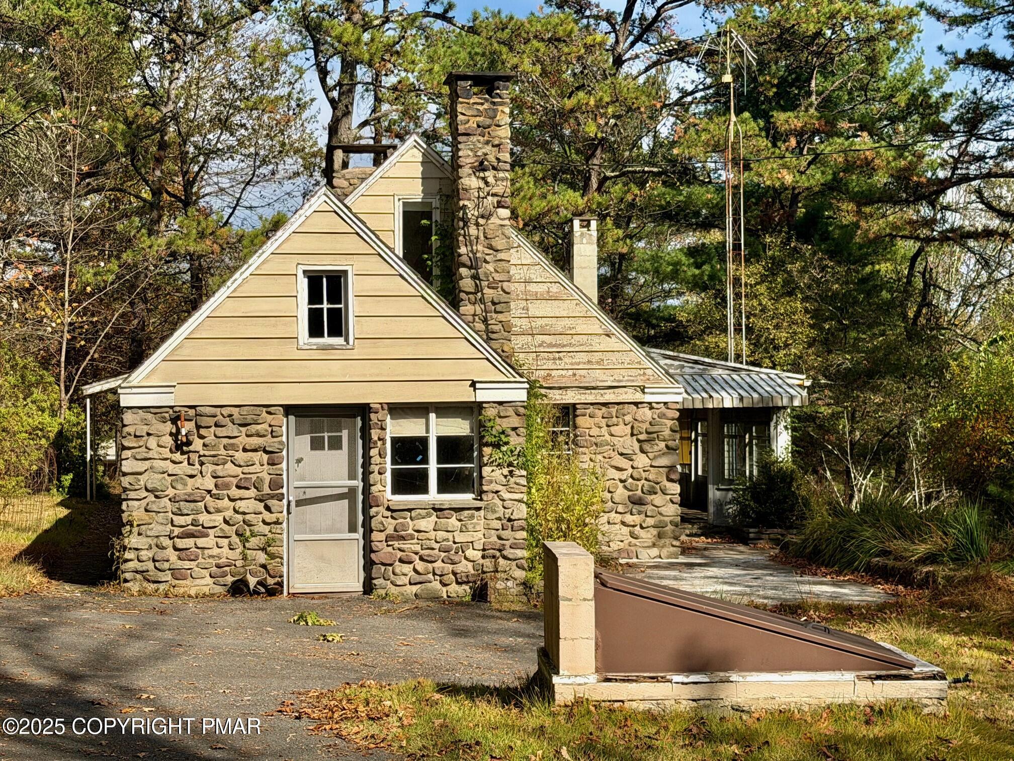 1734 Twin Pine Road Stroudsburg, PA 18360 - Photo 2 of 16 a view of a white house with large windows and a small yard