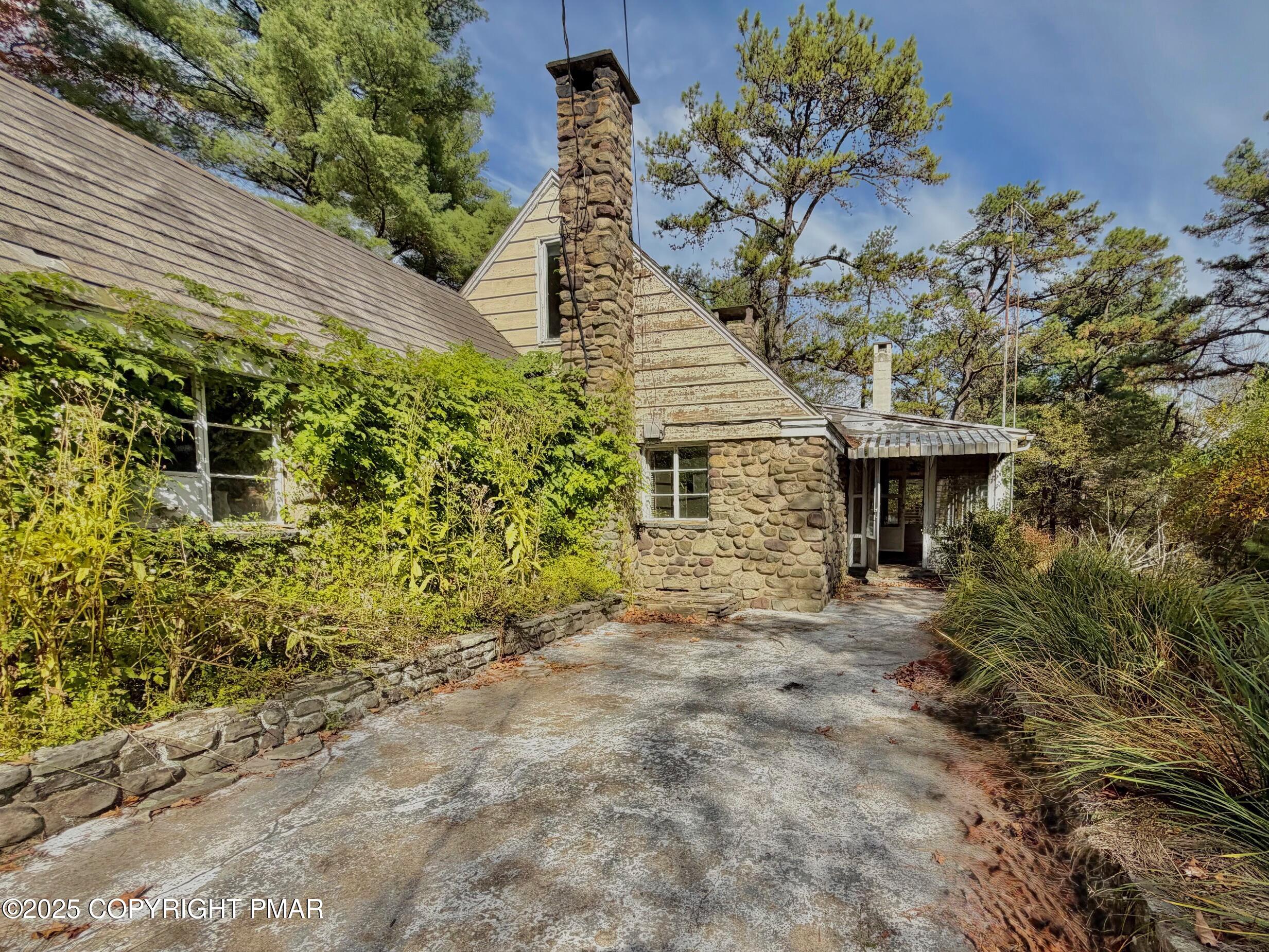 1734 Twin Pine Road Stroudsburg, PA 18360 - Photo 3 of 16 a front view of a house with a garden
