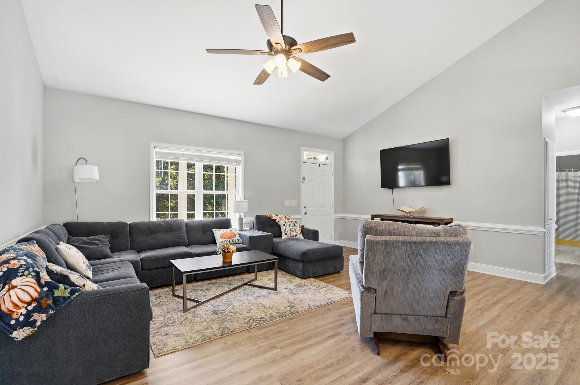 213 Carrie Road Oakboro, NC 28129 - Photo 11 of 40 a living room with furniture and a flat screen tv