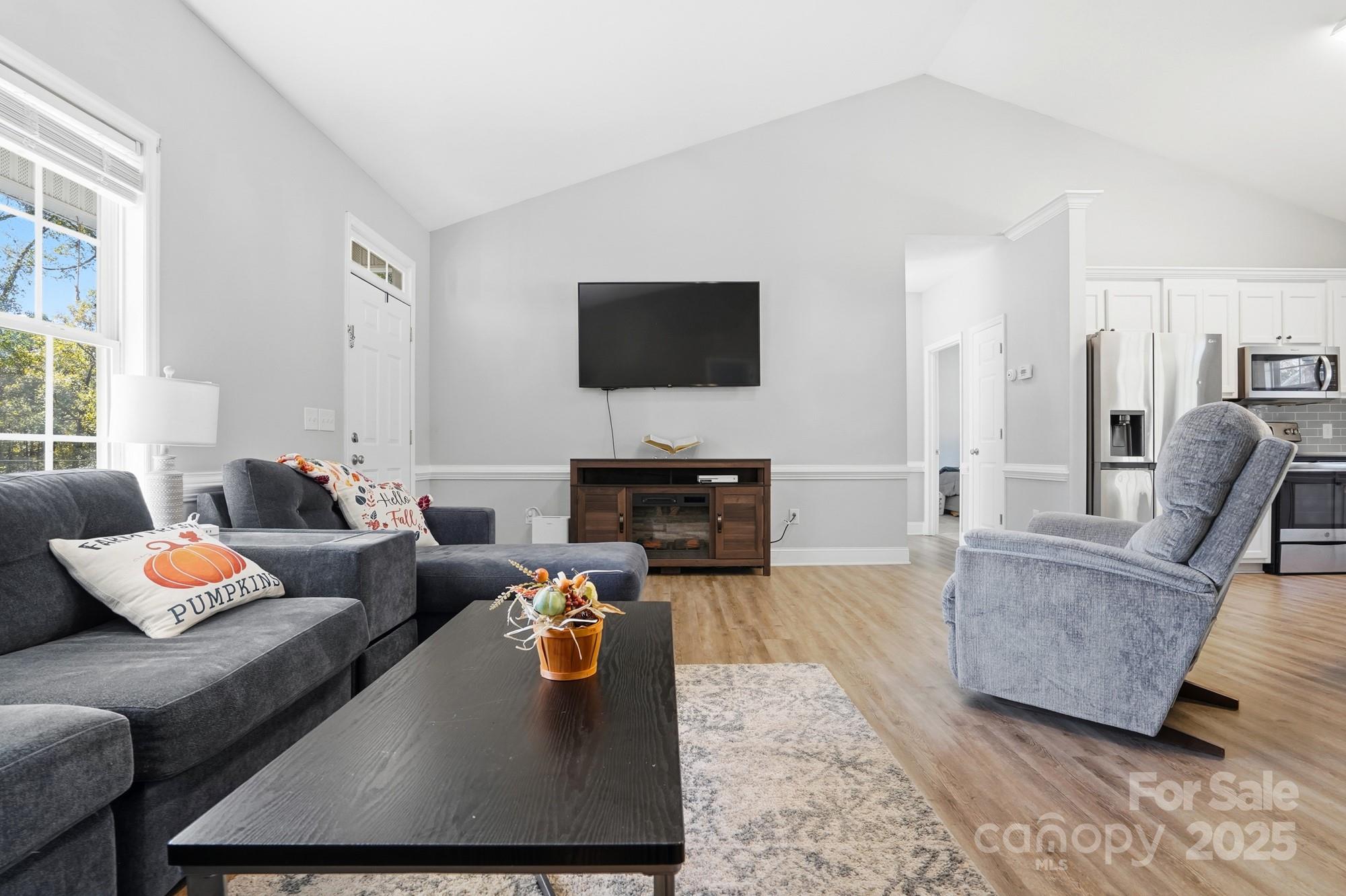 213 Carrie Road Oakboro, NC 28129 - Photo 12 of 40 a living room with furniture and a flat screen tv