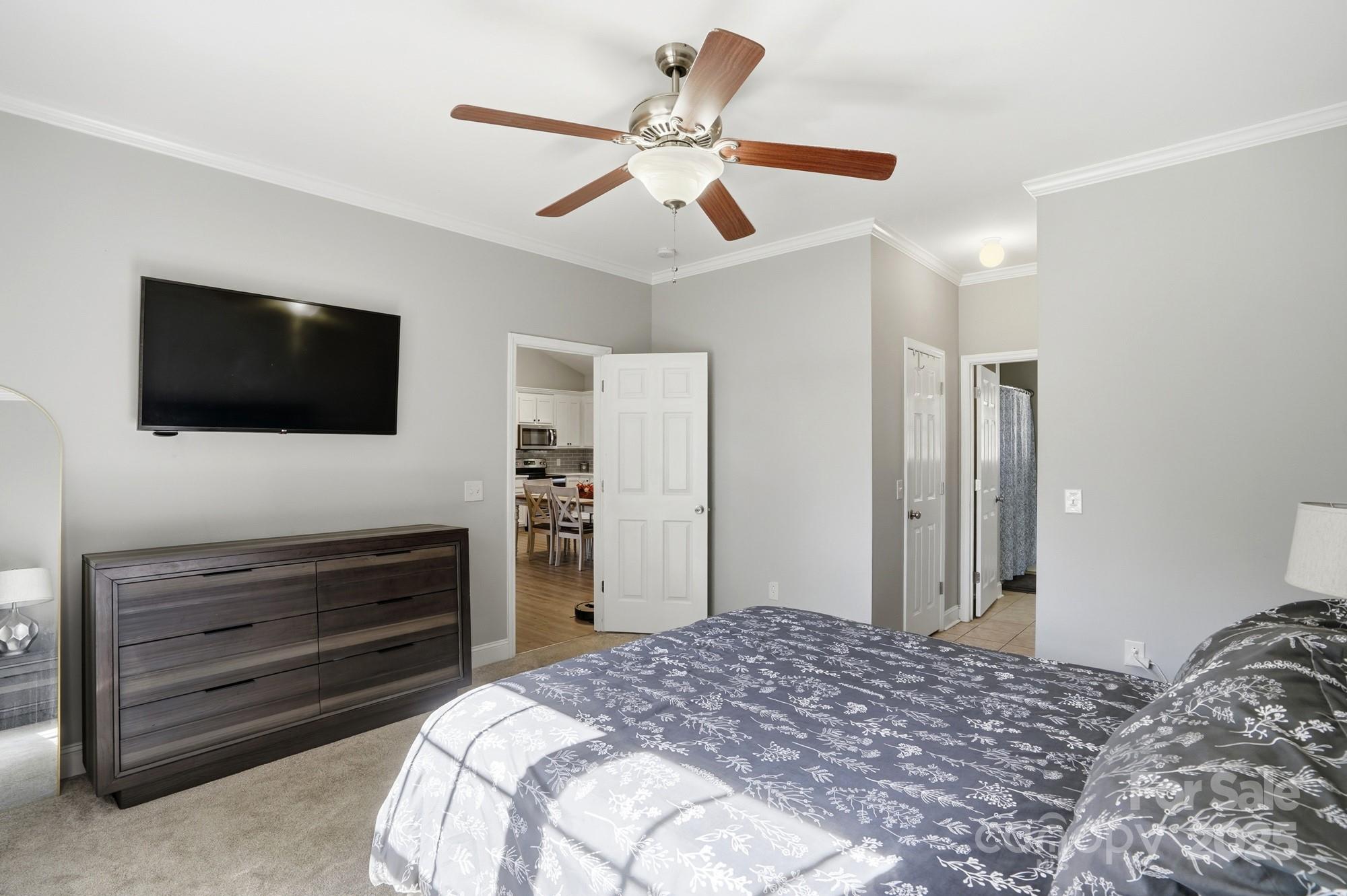 213 Carrie Road Oakboro, NC 28129 - Photo 14 of 40 a bedroom with a bed and a flat screen tv