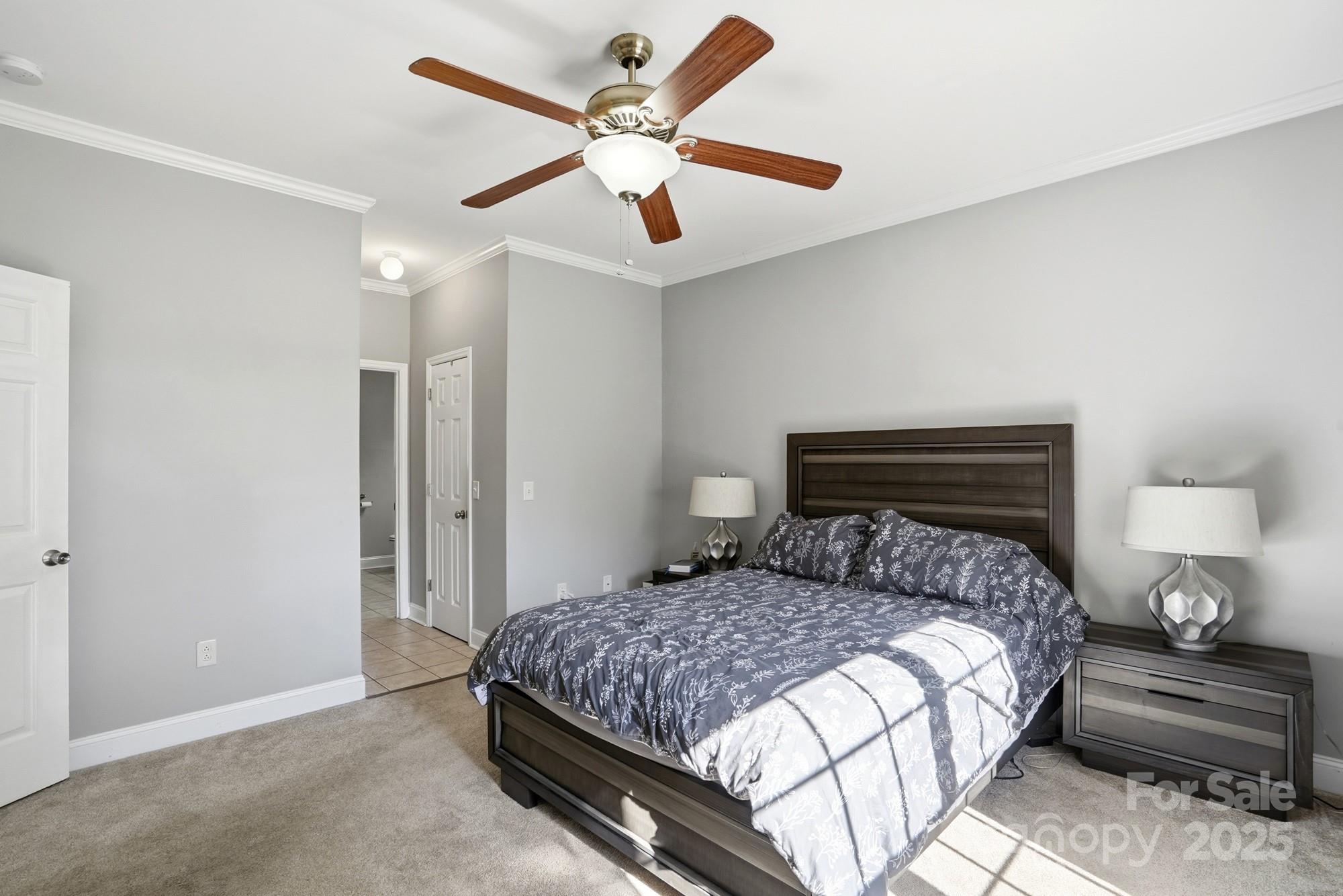 213 Carrie Road Oakboro, NC 28129 - Photo 15 of 40 a bedroom with a large bed and a chandelier