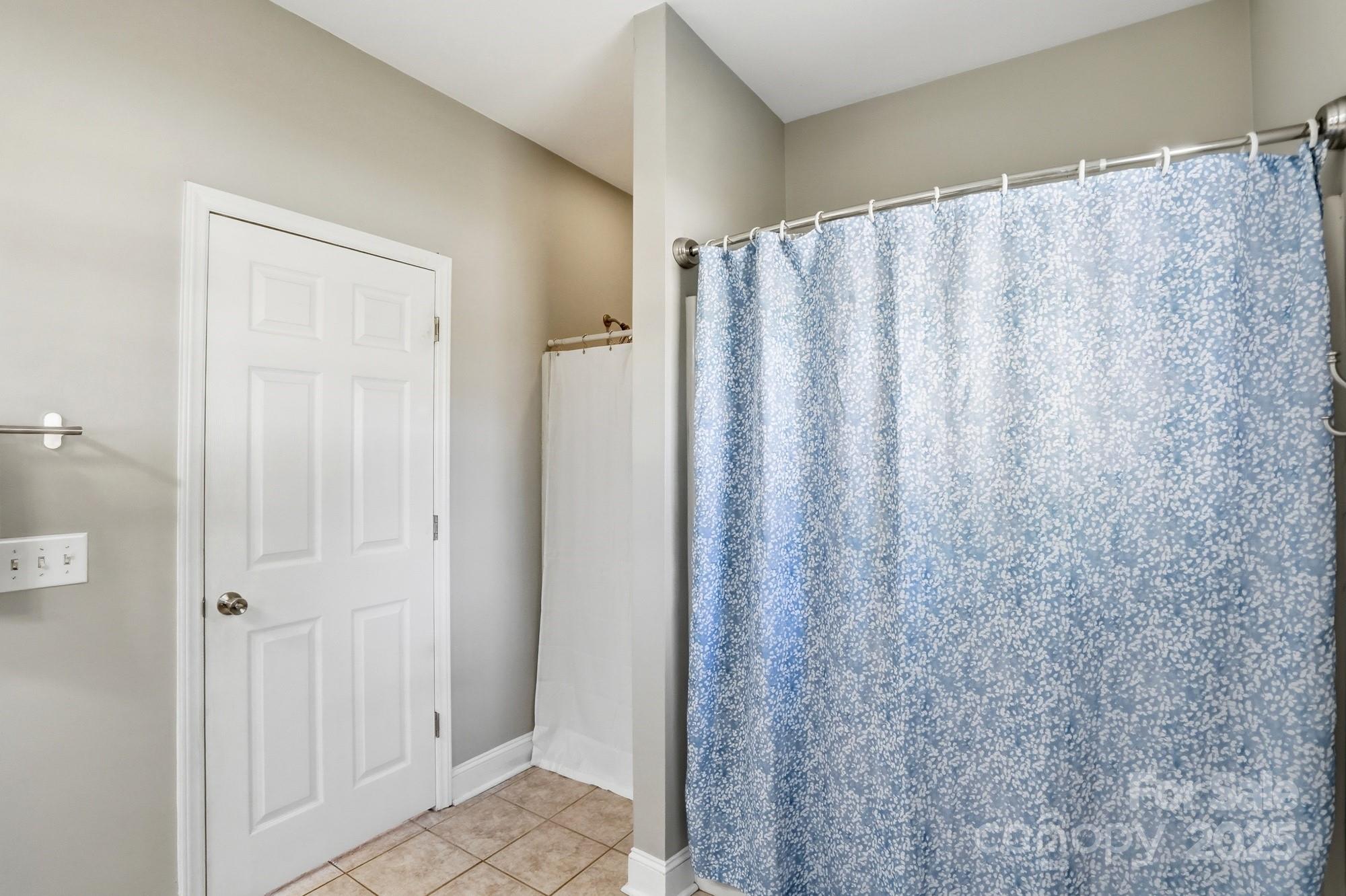 213 Carrie Road Oakboro, NC 28129 - Photo 18 of 40 a view of a bathroom with shower curtain