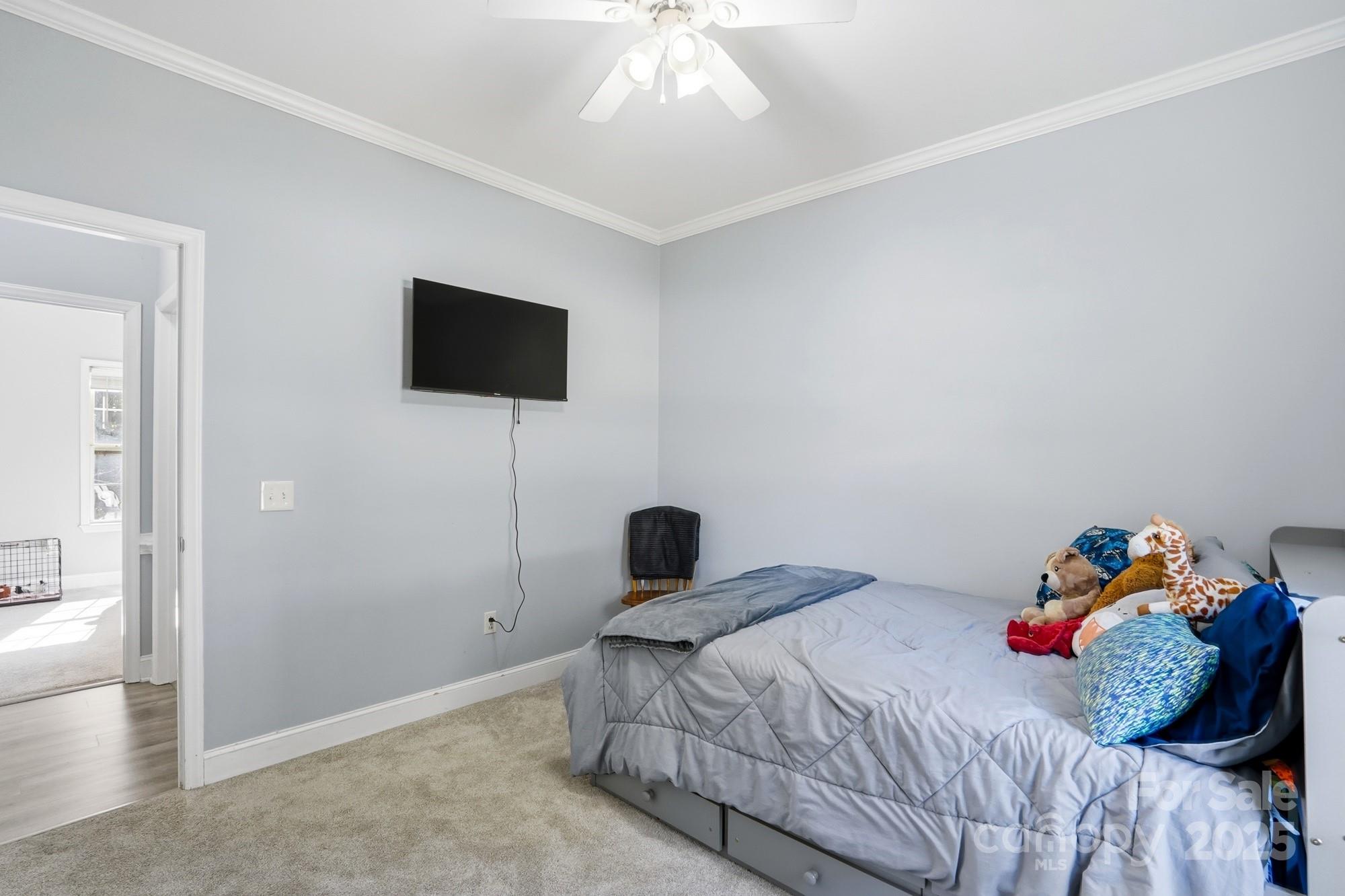 213 Carrie Road Oakboro, NC 28129 - Photo 22 of 40 a bedroom with a bed and a flat screen tv