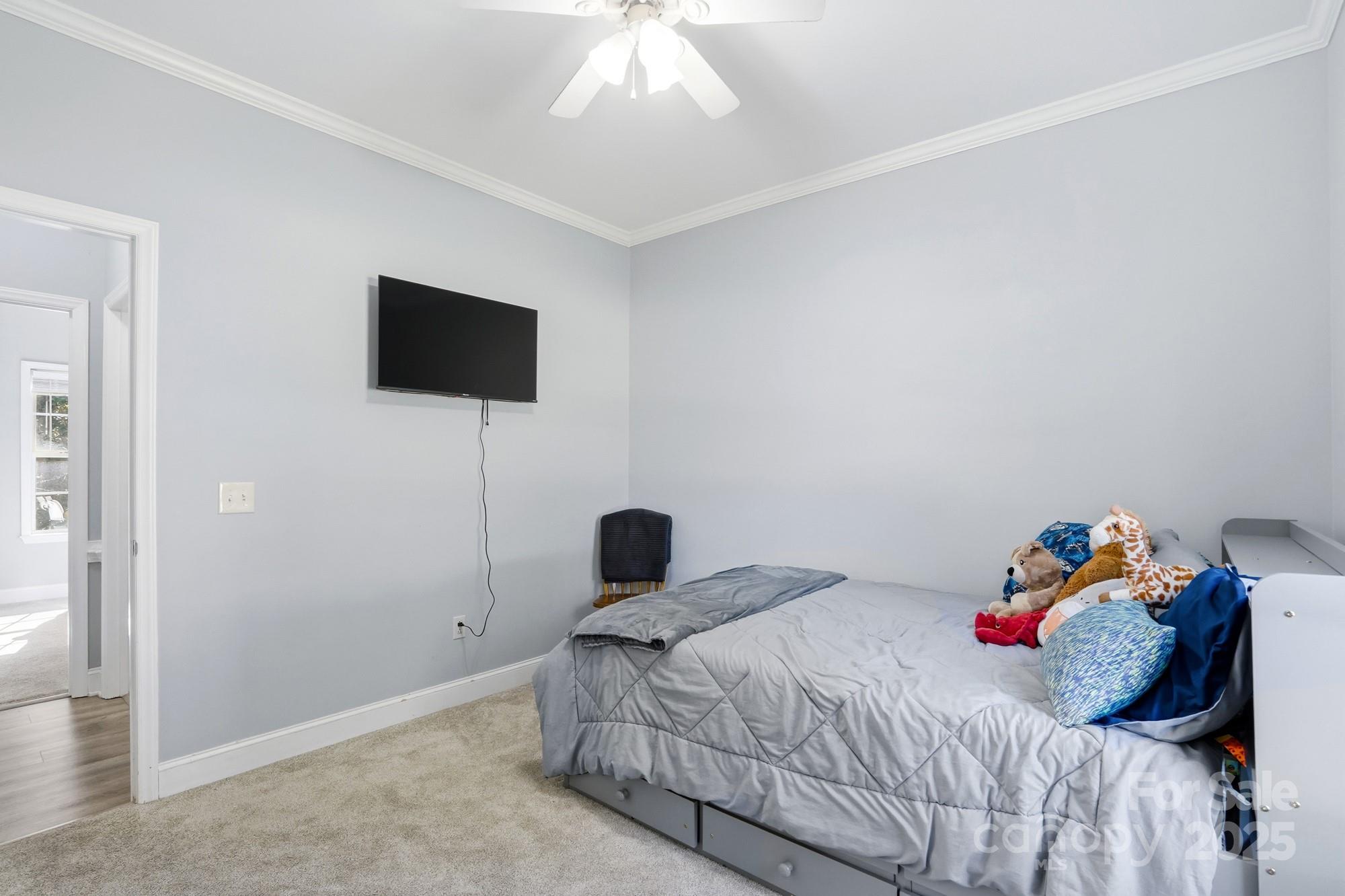 213 Carrie Road Oakboro, NC 28129 - Photo 26 of 40 a bedroom with a bed and a flat screen tv
