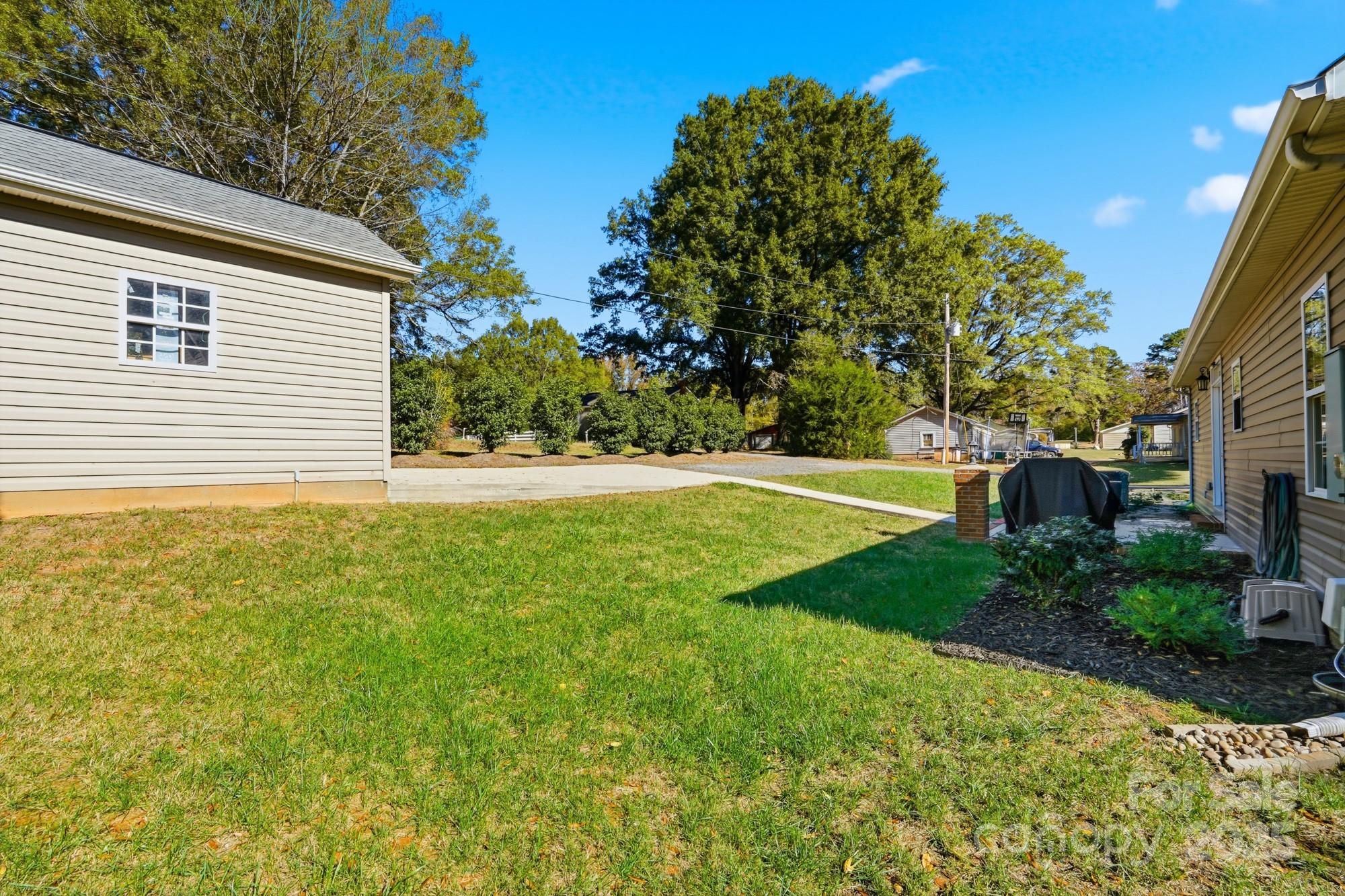 213 Carrie Road Oakboro, NC 28129 - Photo 33 of 40 a view of a backyard with a garden
