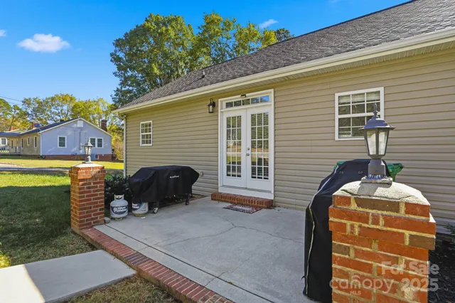 a yellow building in the middle of a yard