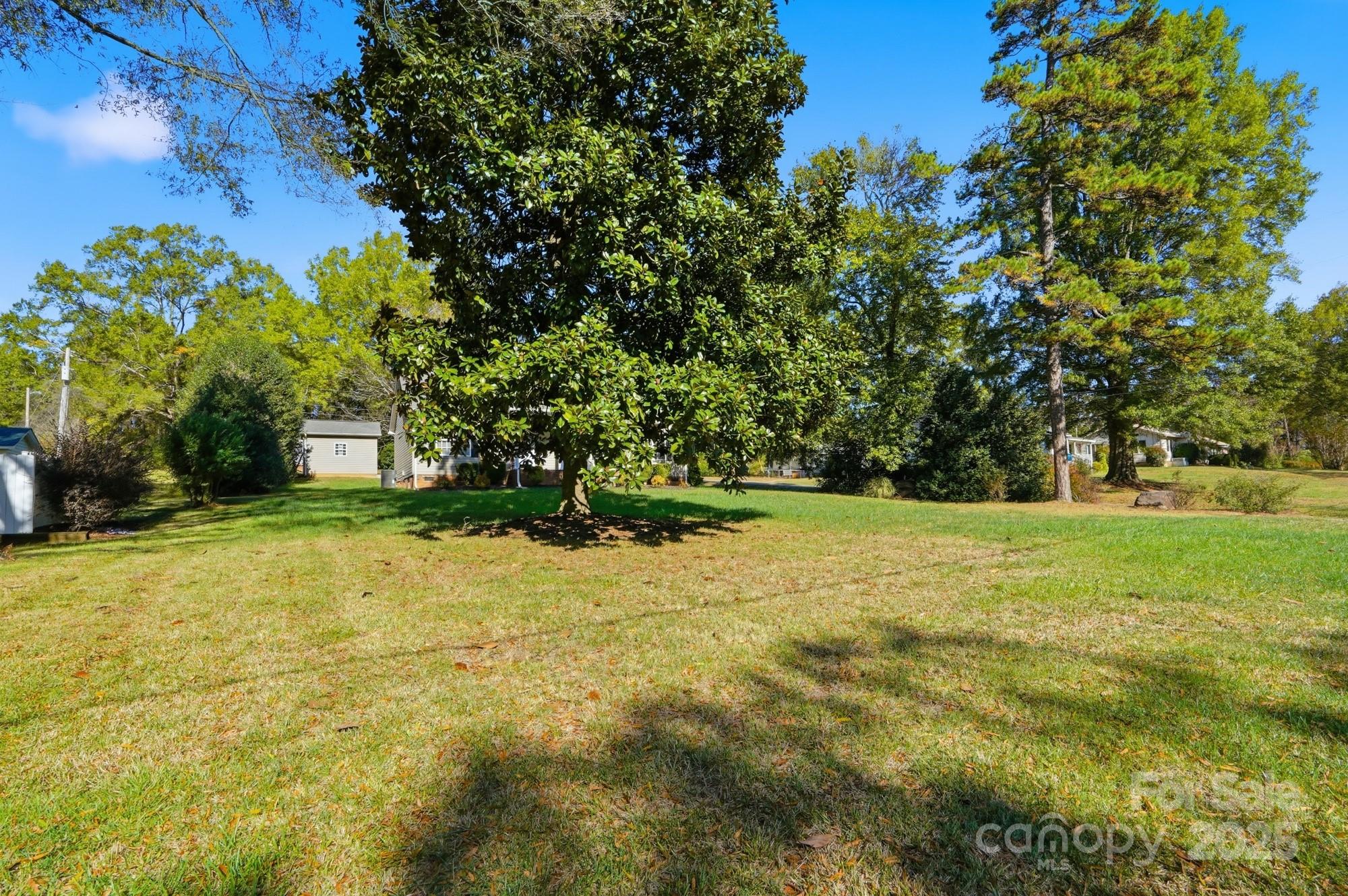213 Carrie Road Oakboro, NC 28129 - Photo 36 of 40 a yellow building in the middle of a yard